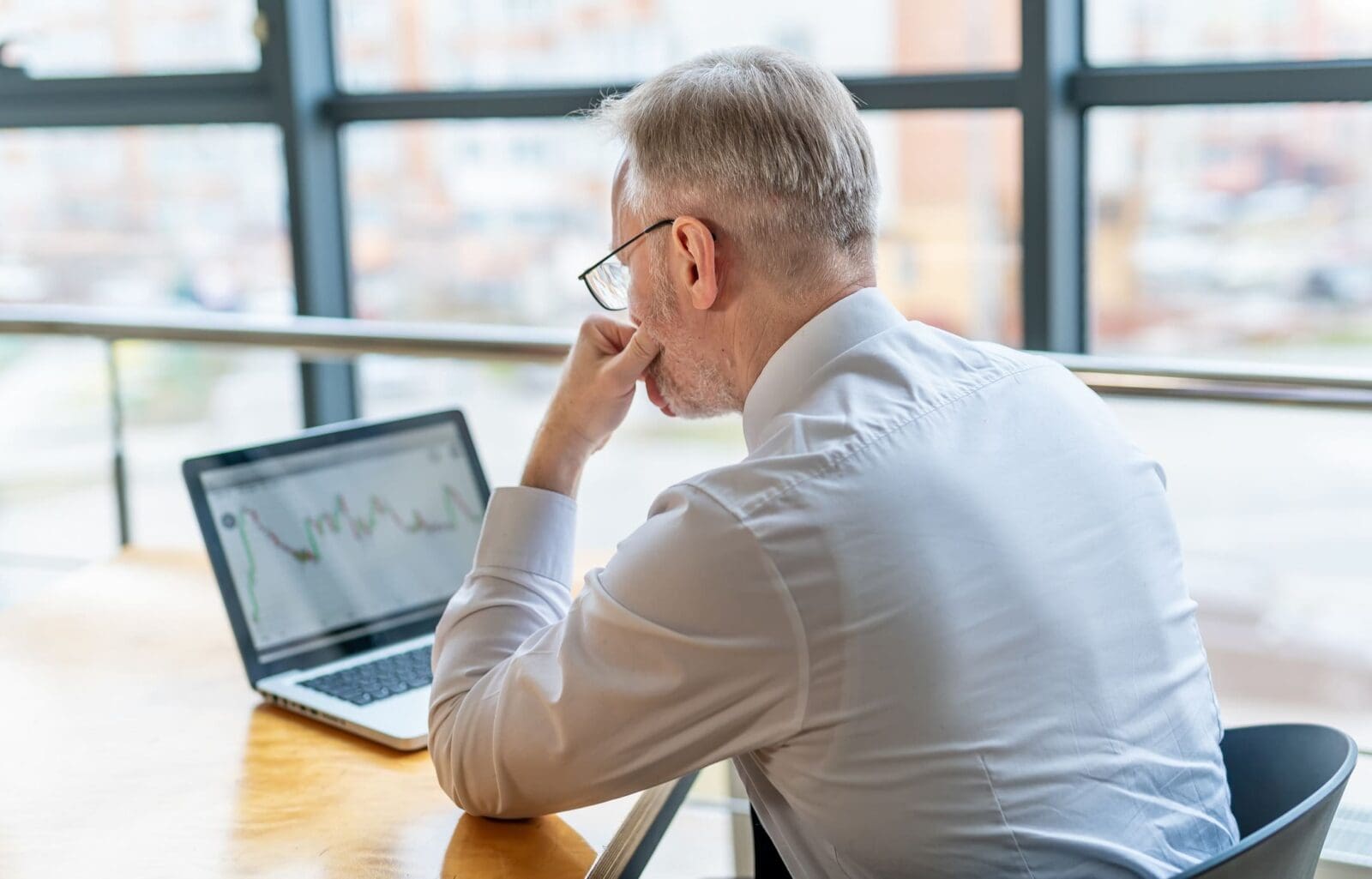 Mature businessman looking thoughtfully at a KPI graph on his laptop. Credit: https://www.istockphoto.com/portfolio/Vadym_Terelyuk?mediatype=photography