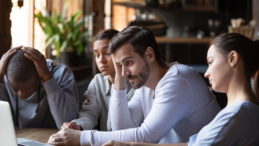 A team of businesspeople looking frustrated and disappointed. Credit: https://www.istockphoto.com/portfolio/fizkes?mediatype=photography