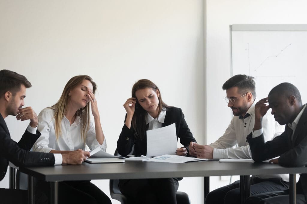 A team feeling confused by a goal they want to measure. Credit: https://www.istockphoto.com/portfolio/fizkes?mediatype=photography