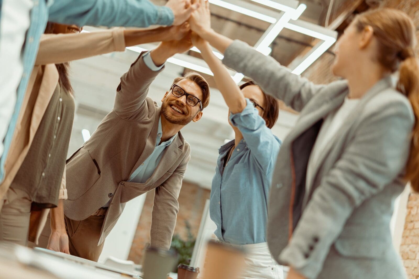 A team giving high-five accepting a new KPI approach. Credit: https://www.istockphoto.com/portfolio/KostiantynVoitenko?mediatype=photography