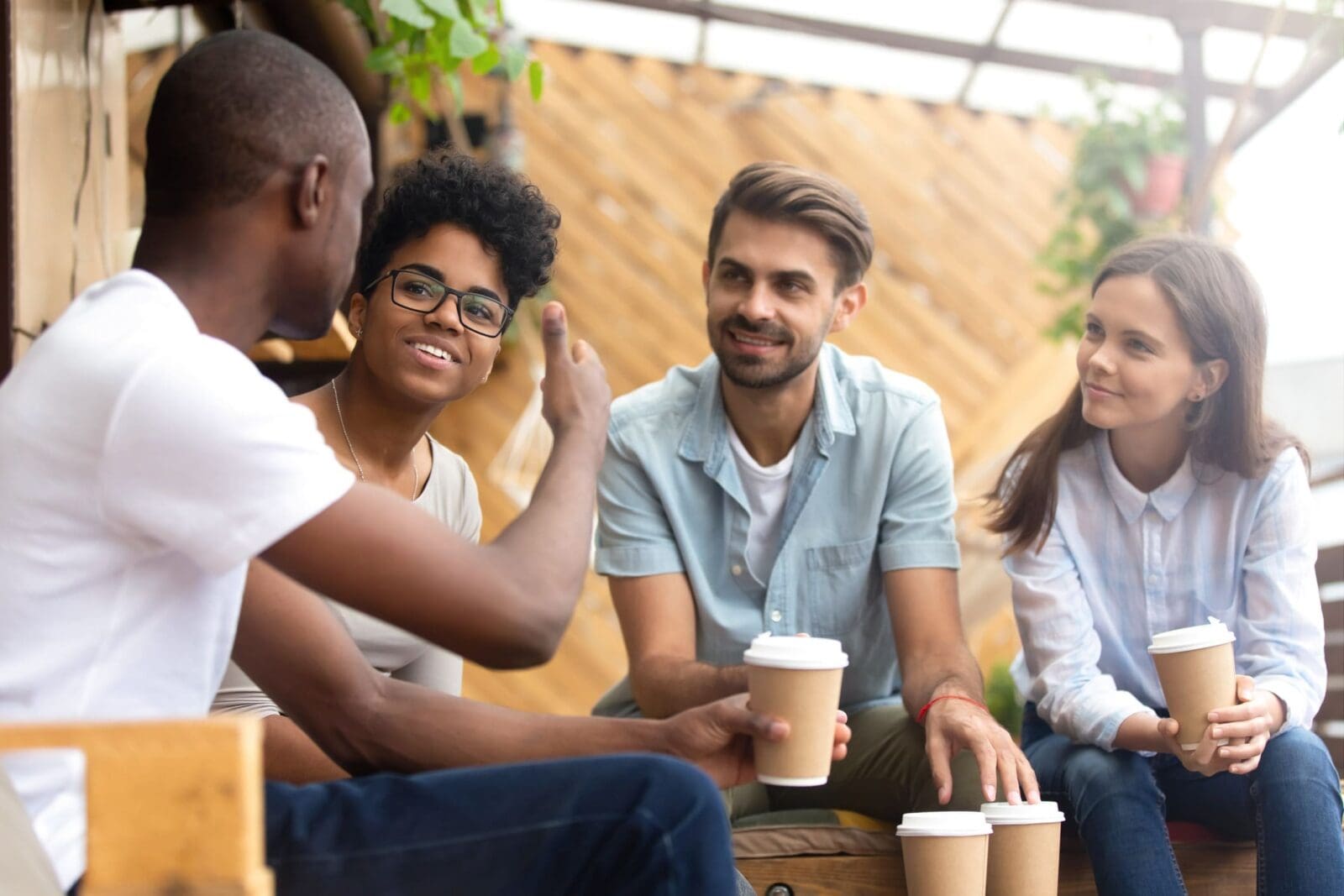 Engaging a group of people over coffee. Credit: https://www.istockphoto.com/portfolio/fizkes?mediatype=photography