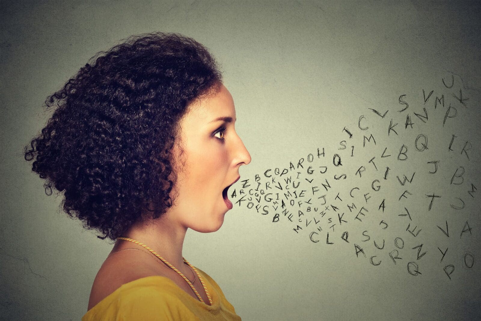 Woman talking with alphabet letters coming out of her mouth. Communication, information, intelligence concept