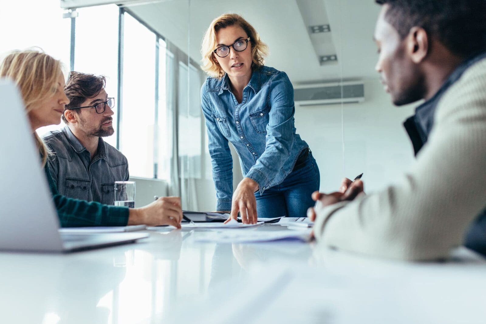 A businesswoman explaining the value of XmR charts to an interested team. Credit: https://www.istockphoto.com/portfolio/jacoblund?mediatype=photography