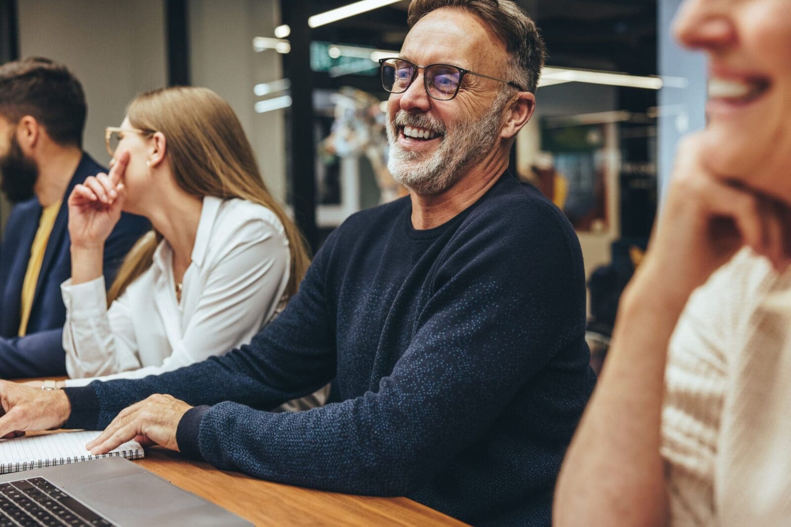 Evidence-Based Leader in boardroom with leadership team, smiling. CREDIT: https://www.istockphoto.com/portfolio/jacoblund