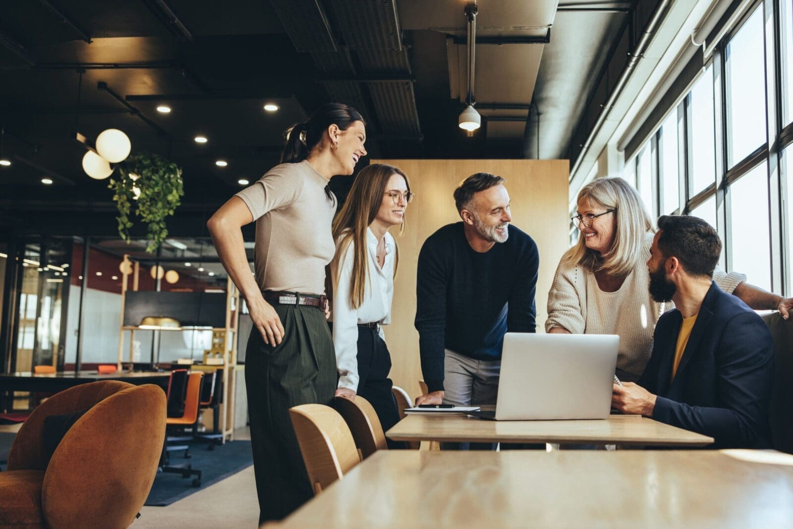 Evidence-Based Leadership team happy with performance displayed on a laptop. CREDIT: https://www.istockphoto.com/portfolio/jacoblund