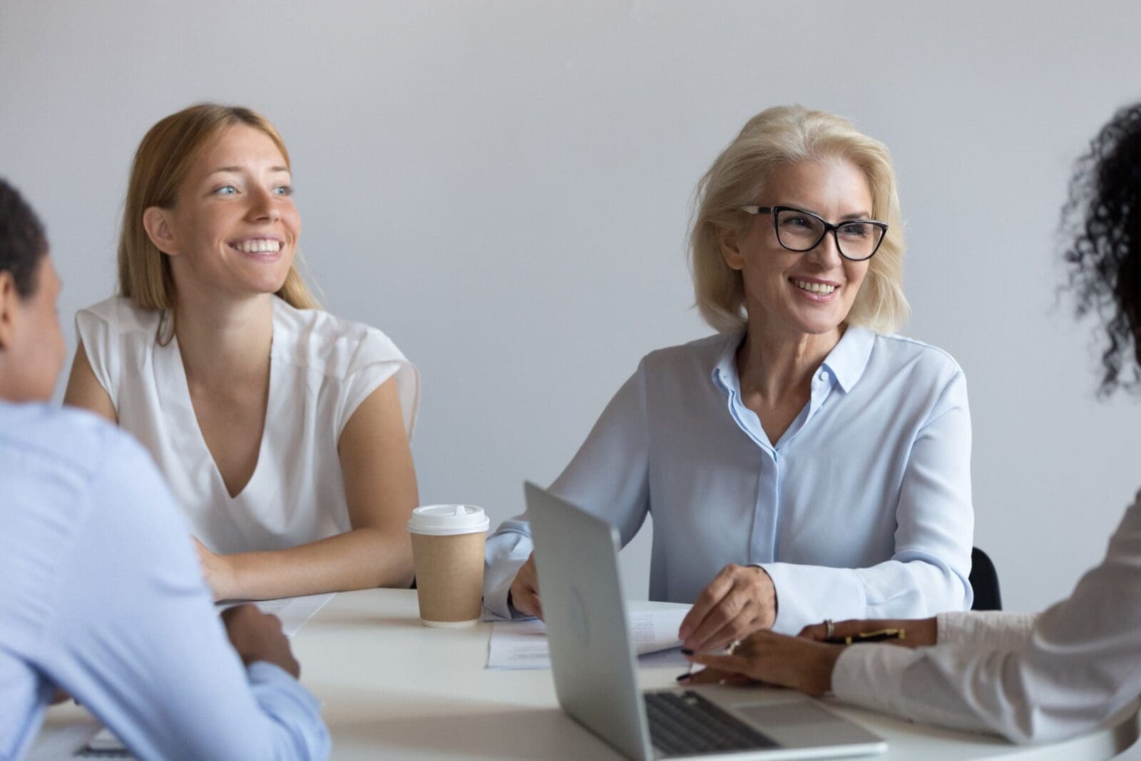 A woman CEO discussing strategic KPI design with her team, role modeling how KPIs start at the top. CREDIT: https://www.istockphoto.com/portfolio/fizkes