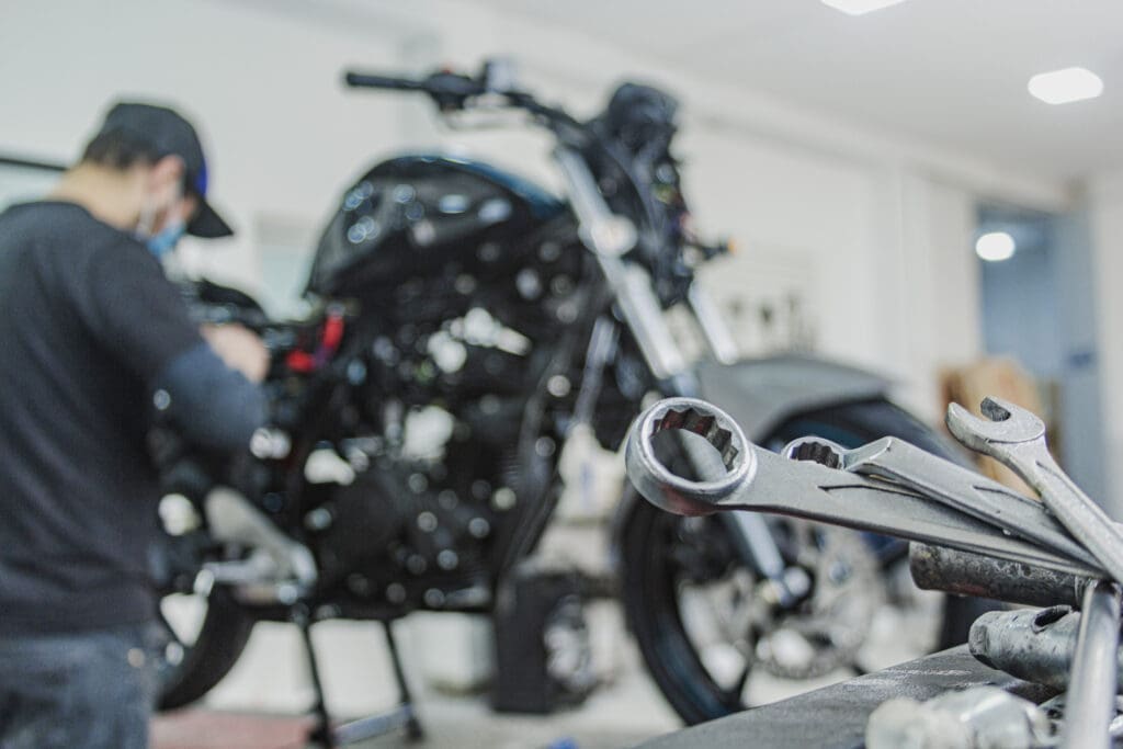 A mechanic usings tools to work on a motorbike . CREDIT: https://www.istockphoto.com/portfolio/rjankovsky