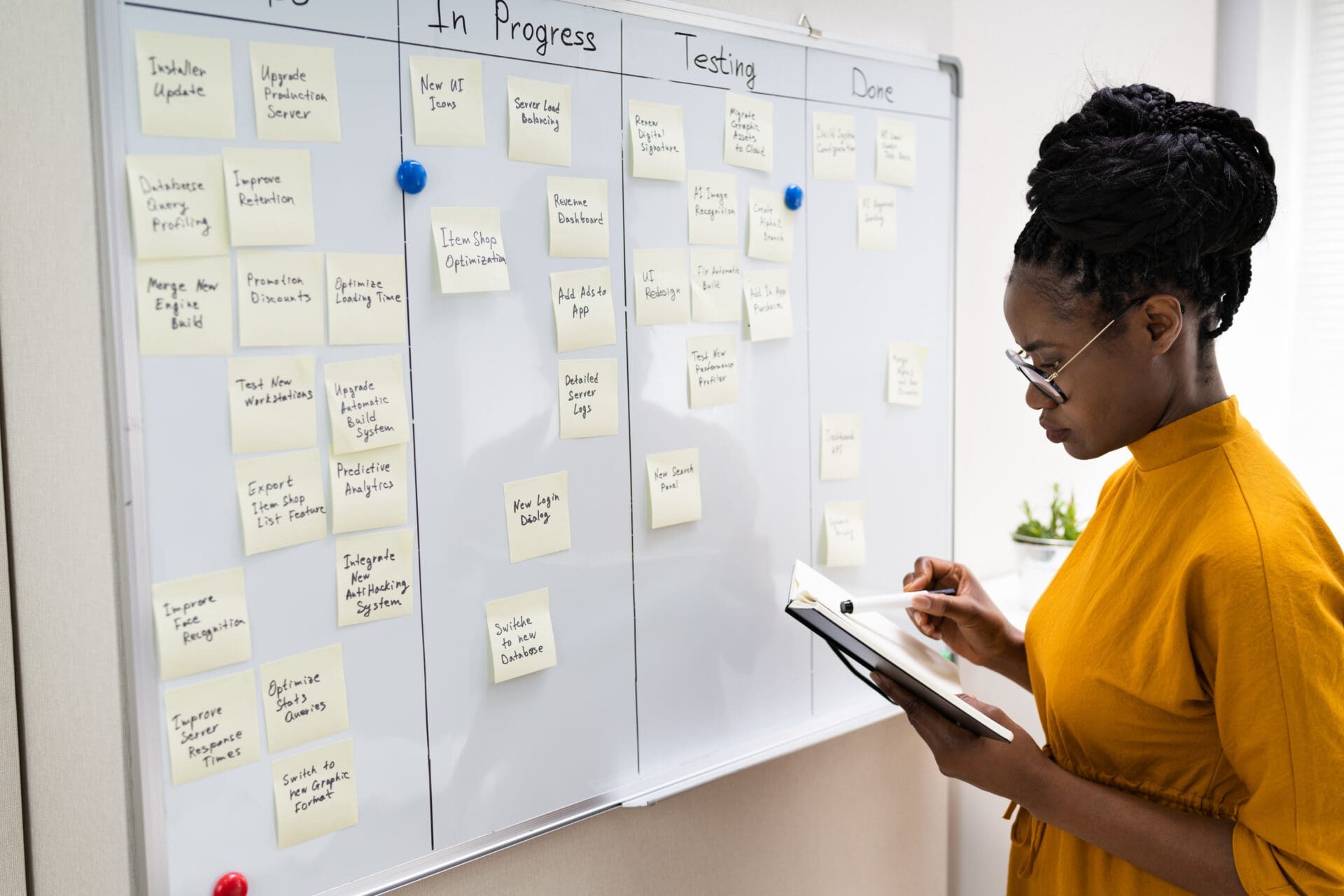 An African woman with a notebook reviewing action progress. CREDIT: https://www.istockphoto.com/portfolio/AndreyPopov