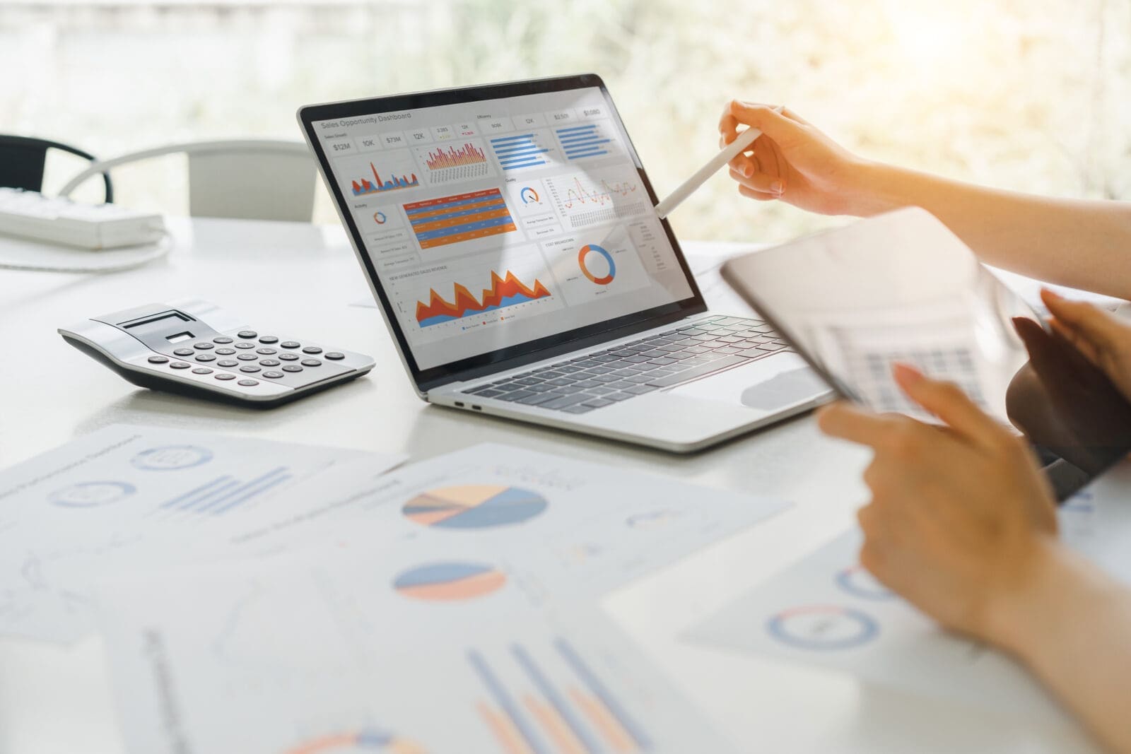 Professional analyzing performance dashboard KPI graphs on laptop display. CREDIT: https://www.istockphoto.com/portfolio/Korrawin