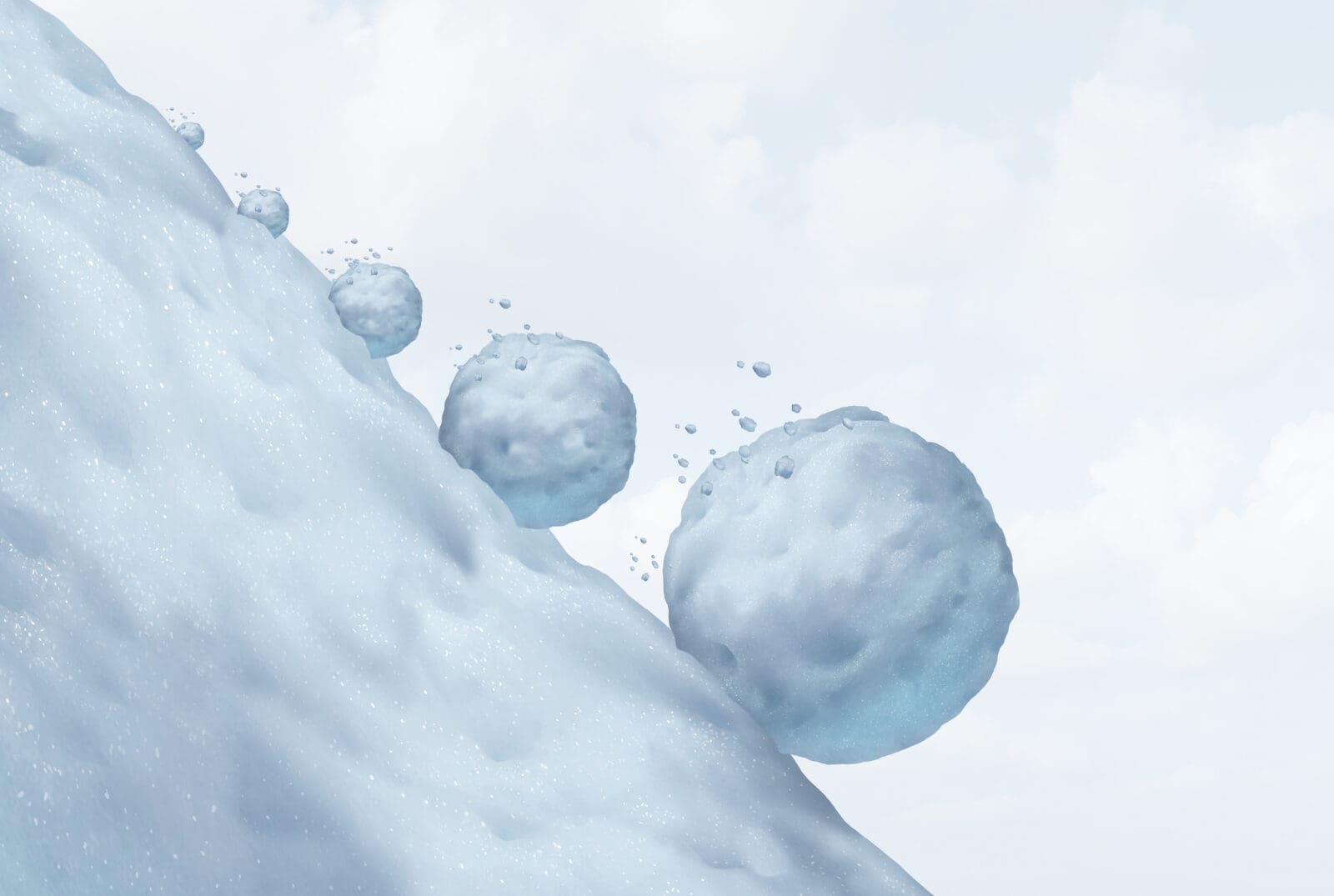 A snowball building in size as it rolls downhill. CREDIT: https://www.istockphoto.com/portfolio/wildpixel